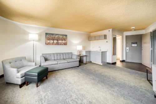 a living room with a couch and a table at Holiday Inn Mobile Downtown Historic District by IHG in Mobile