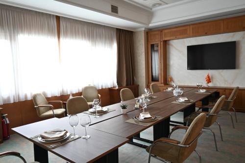 a conference room with a long table and chairs at Aleksandar Palace Hotel Congress Center & SPA in Skopje