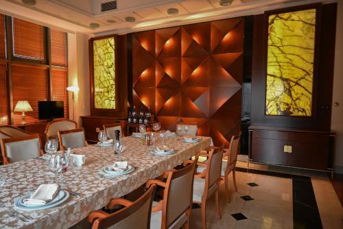 a dining room with a long table and chairs at Aleksandar Palace Hotel Congress Center & SPA in Skopje