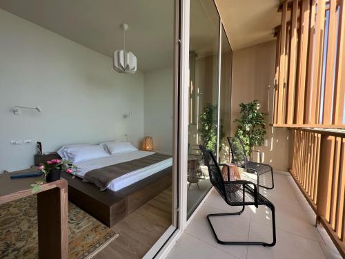 a bedroom with a bed and a sliding glass door at 3-bedroom beach villa with a pool and private sauna in Green Coast Palase in Palasë