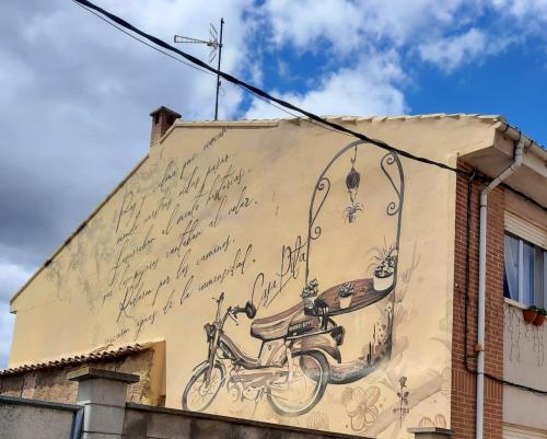 un dipinto di una bicicletta sul lato di un edificio di CASA PITA Siente paz y calma en un lugar con encanto Bbc BTT niños pets a San Justo de la Vega