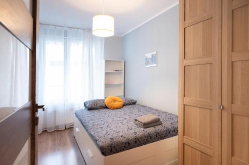 a small bedroom with a bed and a closet at Golden Apartments/Op25 in Katowice