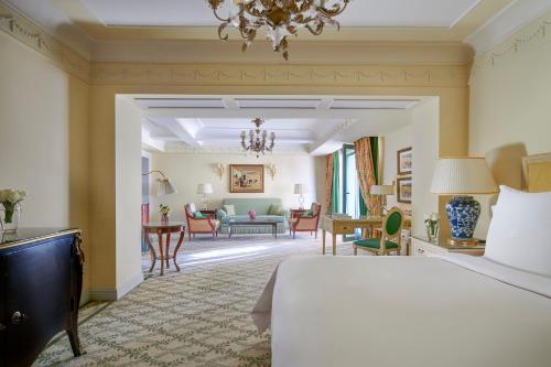 a bedroom with a bed and a living room at Four Seasons Hotel Alexandria At San Stefano in Alexandria