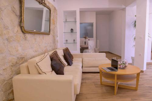 a living room with a white couch and a table at Elizabeth Suites in Kato Daratso