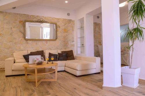 a living room with a couch and a table at Elizabeth Suites in Kato Daratso