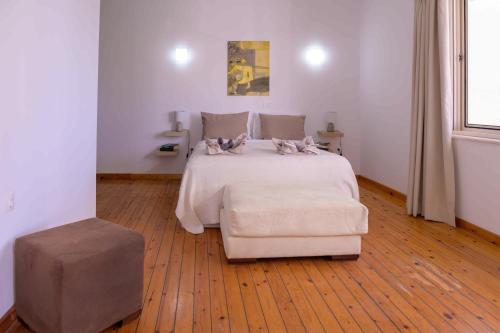 a bedroom with a bed with two dogs on it at Elizabeth Suites in Kato Daratso