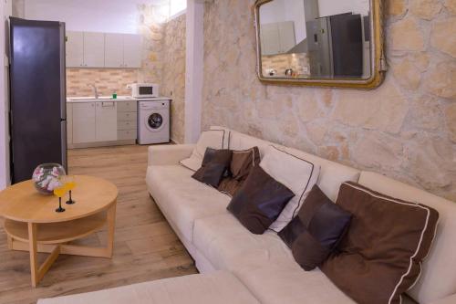a living room with a white couch and a table at Elizabeth Suites in Kato Daratso