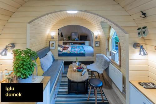 a room with a bed and a table in a tiny house at IGLU SOPOT in Sopot