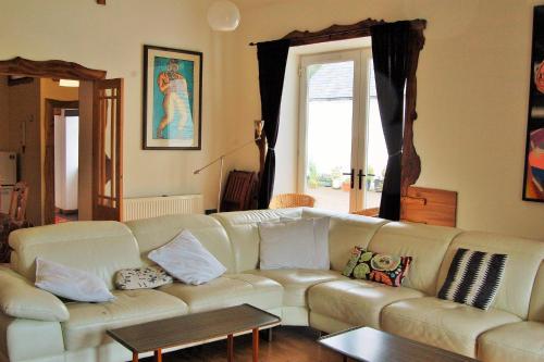 a living room with a white couch and a window at The Annex, Kilbride Farmhouse in Dunoon