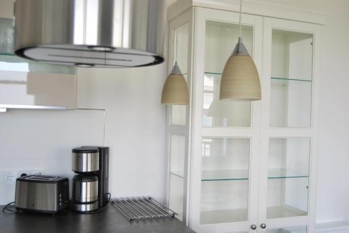 a kitchen with a coffee maker on a counter at Fehmarn-OstseeferienStrandresidenz VogelflugPenthouse 15 in Fehmarnsund