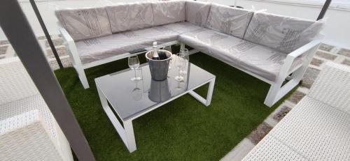 an overhead view of a couch and a table with wine glasses at ArcoSalento in Galatina