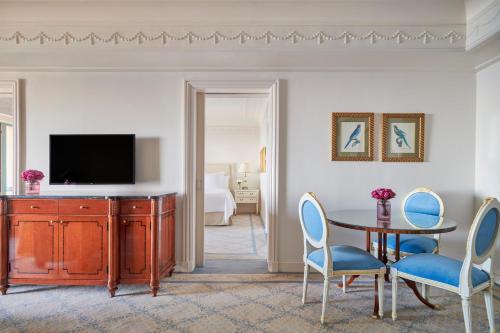 a living room with a television and a table and chairs at Four Seasons Hotel Alexandria At San Stefano in Alexandria