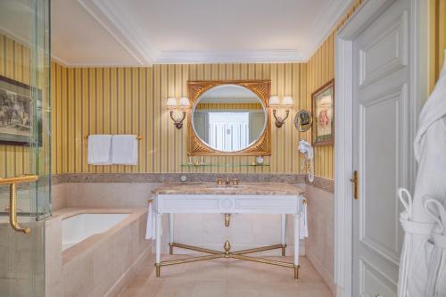 a bathroom with a sink and a tub and a mirror at Four Seasons Hotel Alexandria At San Stefano in Alexandria