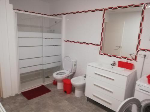 a bathroom with a toilet and a sink and a mirror at Chajofe 8 in Los Cristianos