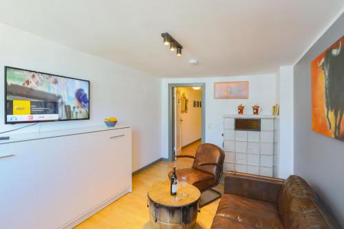 a living room with a couch and a table at Apartments im Einhornhaus in Lübeck