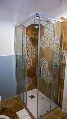 a shower with a glass enclosure in a bathroom at Castellabate Apartments Camere in Castellabate