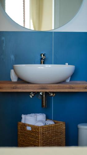 a bathroom with a white sink and a mirror at Castellabate Apartments Camere in Castellabate