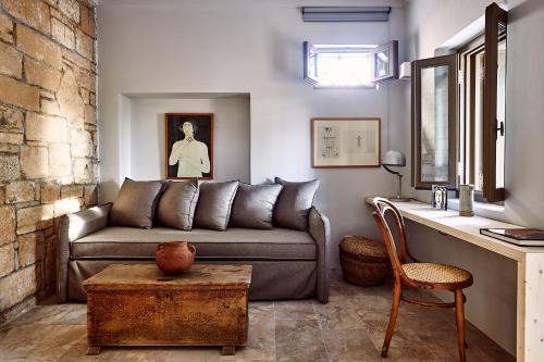 a living room with a couch and a table at Nikolaou Art Residence in Aegina Town