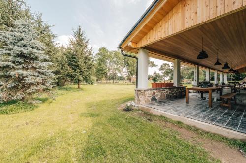 a porch of a house with a picnic table at Farma Mračov in Kadov