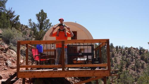 a man standing on the balcony of a house at Zion View Camping in Hildale