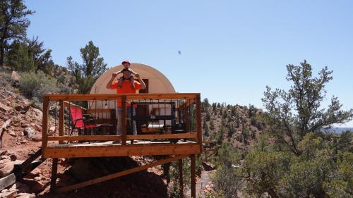 a man is standing in a tree house at Zion View Camping in Hildale