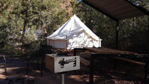 a white tent with a sign in front of it at Zion View Camping in Hildale