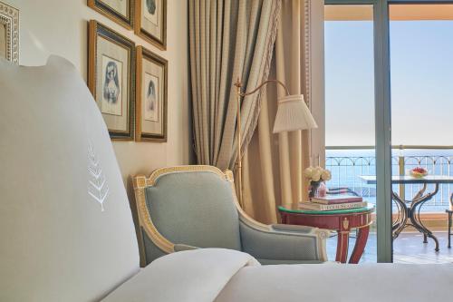 a bedroom with a bed and a table and a balcony at Four Seasons Hotel Alexandria At San Stefano in Alexandria