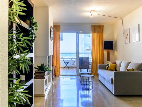 a living room with a couch and a view of the ocean at Estepona Marina with Sea Views, Pool and Parking in Estepona