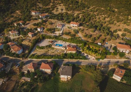 an aerial view of a house on a hill at Traditional house Alexis Coco with pool and fire place in Tríkorfon