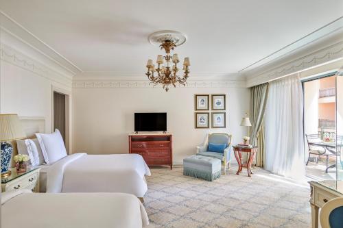 a hotel room with two beds and a television at Four Seasons Hotel Alexandria At San Stefano in Alexandria