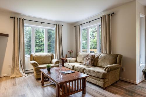a living room with a couch and two chairs and a table at Aiglon by Rendez-Vous Mont-Tremblant in Mont-Tremblant