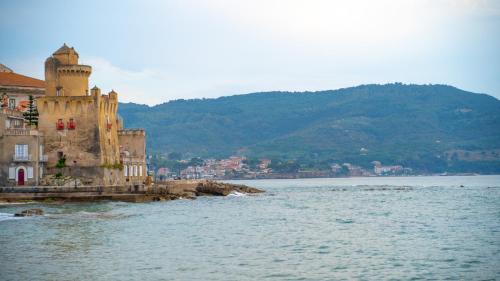 a building on the shore of a body of water at Castellabate Apartments Camere in Castellabate
