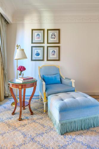 a living room with a blue couch and a table at Four Seasons Hotel Alexandria At San Stefano in Alexandria