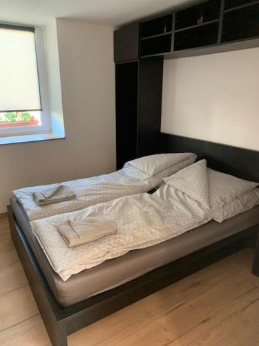 a bed with two towels on it in a bedroom at Loft Pihenő és Wellness Ház in Balatonfüred