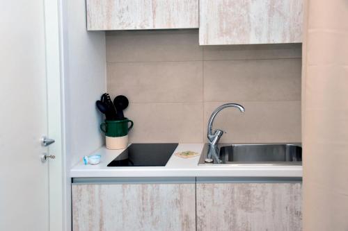 a kitchen counter with a sink and utensils at Tenuta l'Alba di Monte Matino - Mobil Home in Otranto