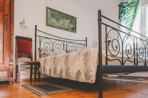 a bedroom with a bed and a chair at Villa Irbe in Jūrmala