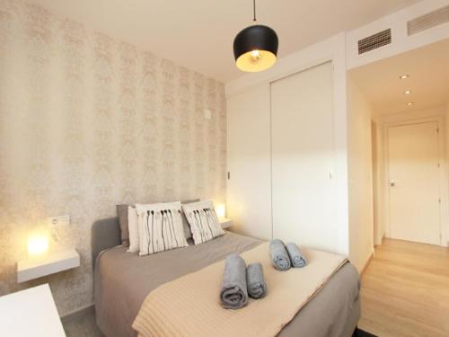 a bedroom with a bed with two pillows on it at 2 bedroom Penthouse with a private 360 rooftop terrace with sea and mountain views in Bahia de Casares