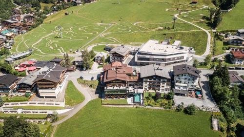 an aerial view of a building with a park at Hotel Kohlmais in Saalbach-Hinterglemm