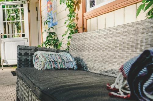 a couch with a pillow sitting on a porch at Villa Irbe in Jūrmala