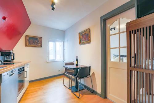 a kitchen with a table with a chair in it at Apartments im Einhornhaus in Lübeck