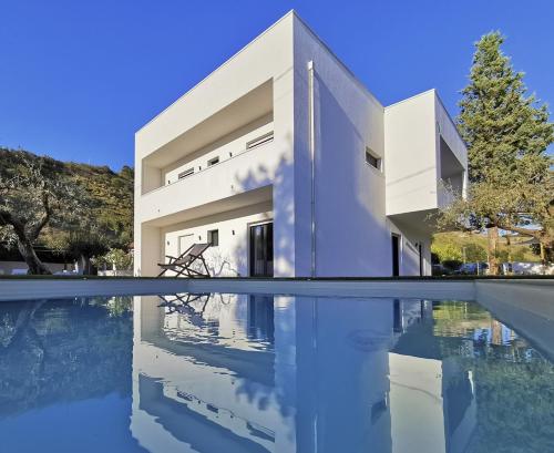 a house with a pool in front of it at Green Land Boutique Hotel in Castilenti