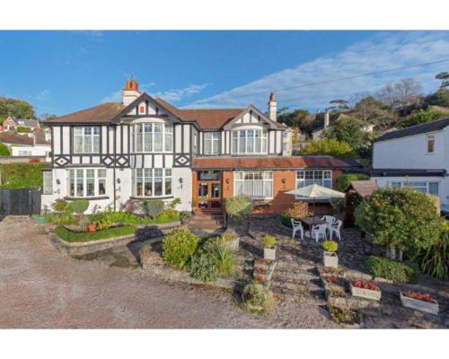 a large house with a garden in front of it at Newton House in Torquay