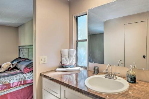 a bathroom with a sink and a bed at Suwannee Riverfront Home Grill, Near Springs in Branford