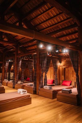 a room with a bunch of beds in a building at Maison Teahouse homestay in Ha Giang