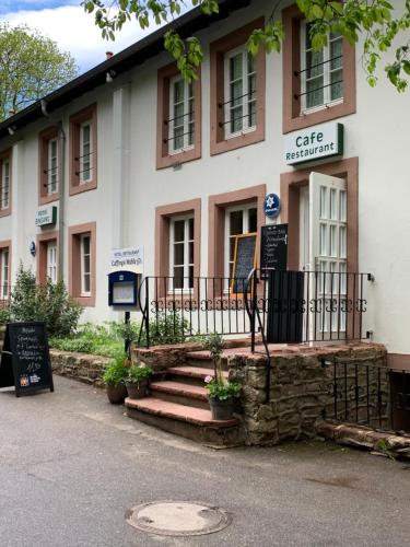 a building with a gate in front of it at Hotel Restaurant El Greco bei der Taffingsmühle in Saarlouis