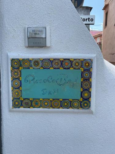 a sign on the side of a white building at Piccolo Bed in Procida