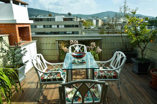 a table and two chairs on a balcony at Orchid House - T1 Apartment in Braga
