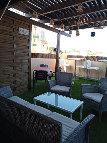 a patio with couches and a table and chairs at L'Hostalet d'Arenys de Mar in Arenys de Mar