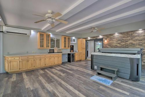 a large kitchen with a ceiling fan and wooden cabinets at Coastal Edgewater Home with Private Hot Tub! in Annapolis