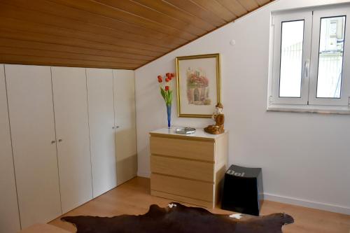 a room with a dresser and a window at Orchid House - T1 Apartment in Braga